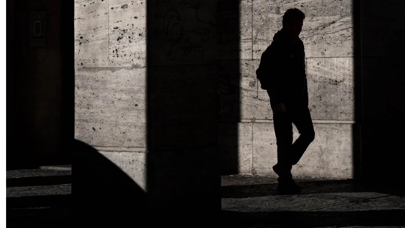A Man Walks in the Shadows